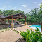1203 Woodridge Cir - Backyard View of Swimming Pool and Covered Patio